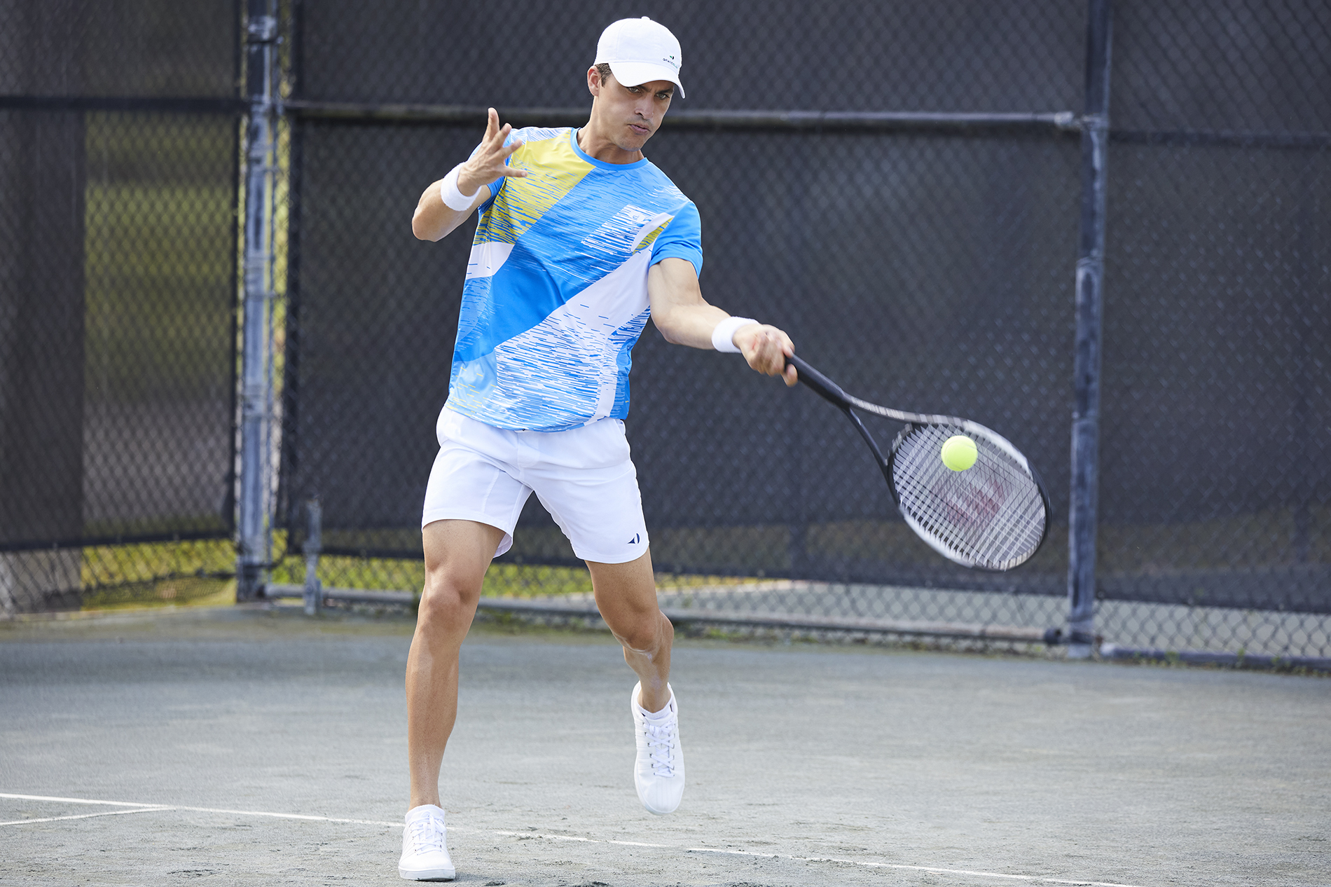 Player wearing a Grand Slam polo shirt.